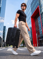 Man pulling PARA JOHN VELTRIX Black suitcase in the city