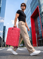 Man pulling PARA JOHN VELTRIX Pink suitcase in the city
