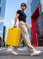 Man pulling PARA JOHN VELTRIX Yellow suitcase in the city